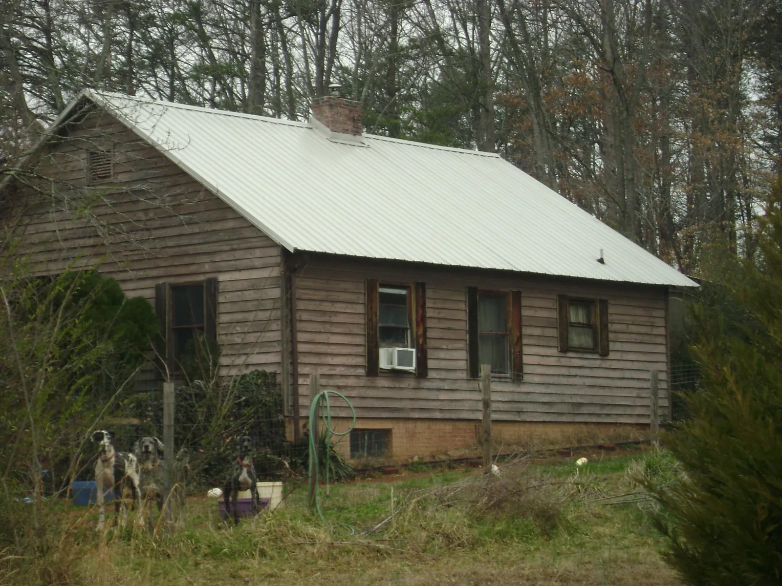 White metal roof on an old wood sided farmhouse, from a Metal Roof Installation job in Earlysville